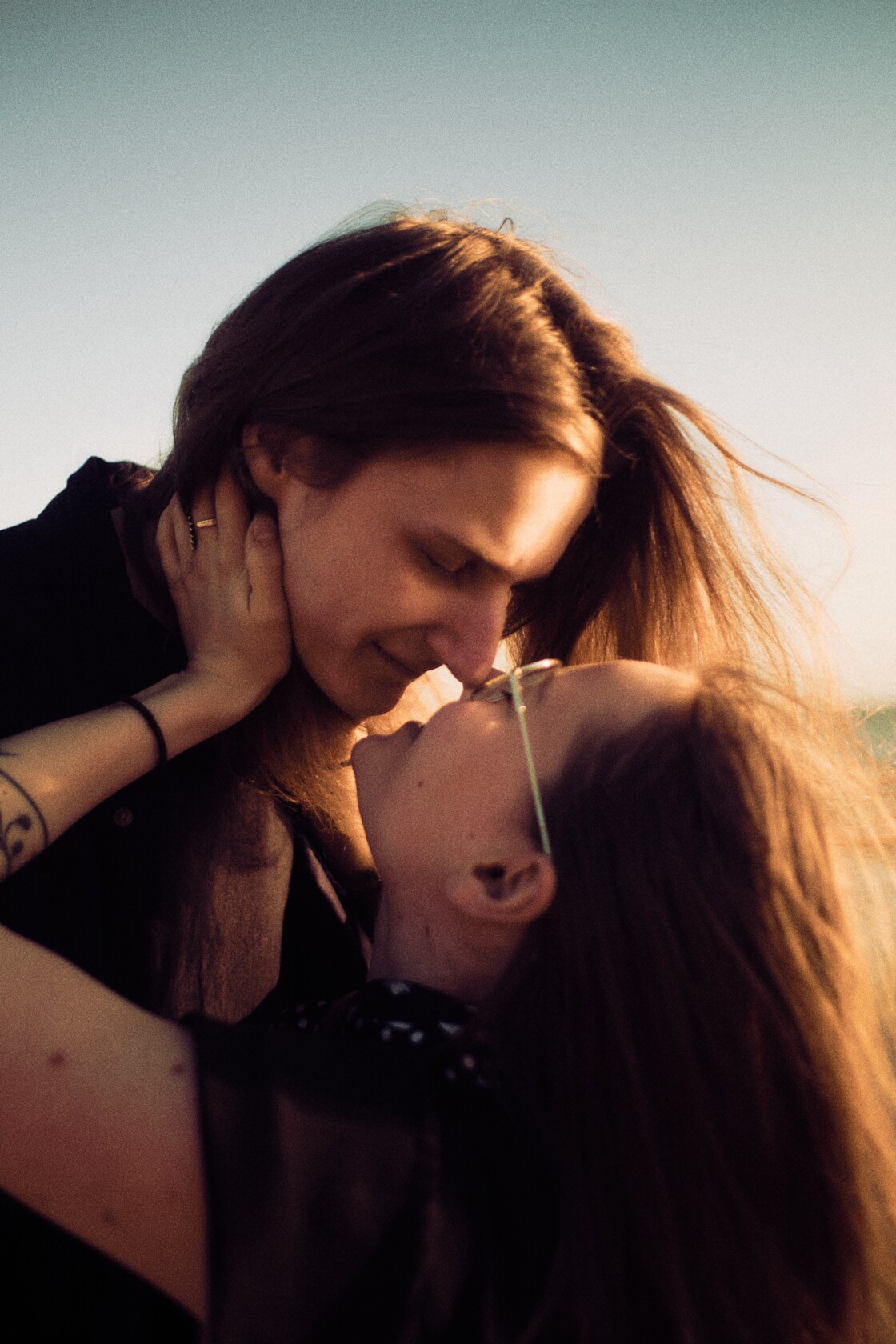 Paarifotograafia nina puudutus varvastel veepiiril hellalt
